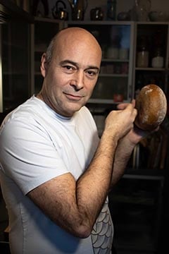 Rene DeMartin holding freshly baked bread. 